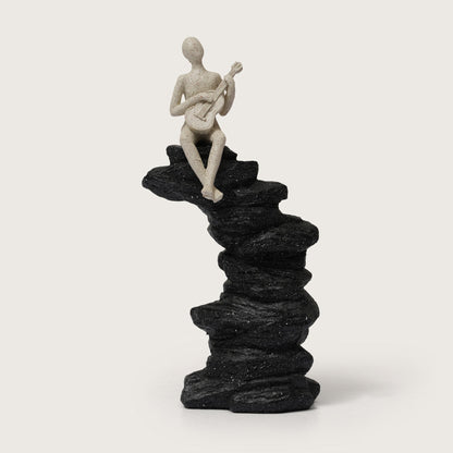 Guitarist Figurine on Stacked Rock Sculpture