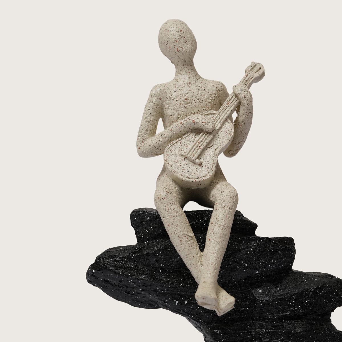 Guitarist Figurine on Stacked Rock Sculpture