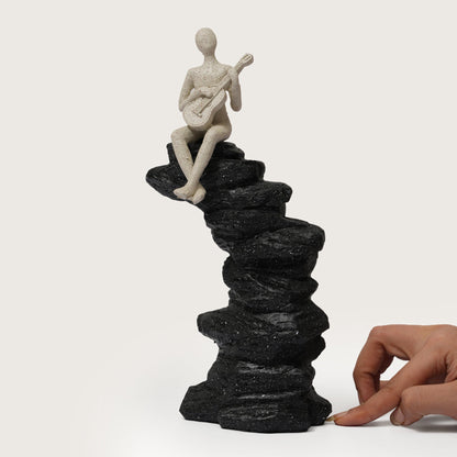 Guitarist Figurine on Stacked Rock Sculpture