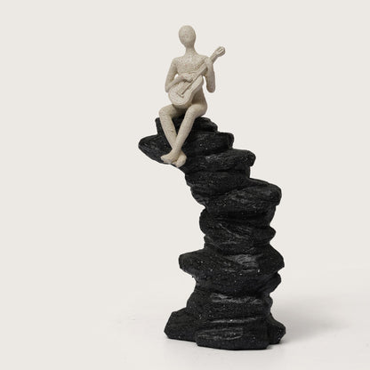 Guitarist Figurine on Stacked Rock Sculpture