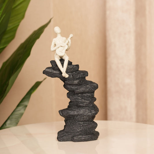 Guitarist Figurine on Stacked Rock Sculpture